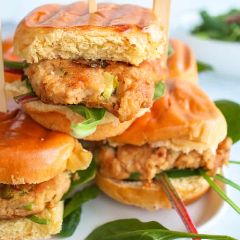 Close up of Tuna Burgers on Brioche Buns with fresh Spinach.