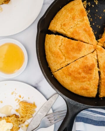 Southern Cornbread in a cast iron skillet with butter and honey
