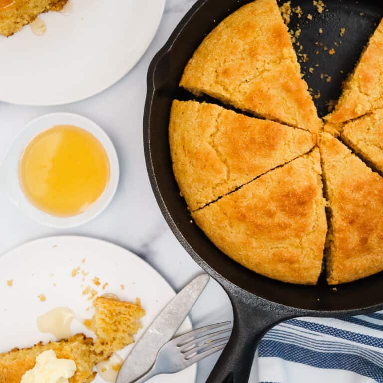 Southern Cornbread in a cast iron skillet with butter and honey
