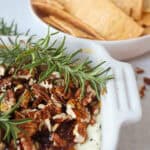 Baked Goat Cheese topped with fig jam, chopped pecans, honey, and fresh rosemary