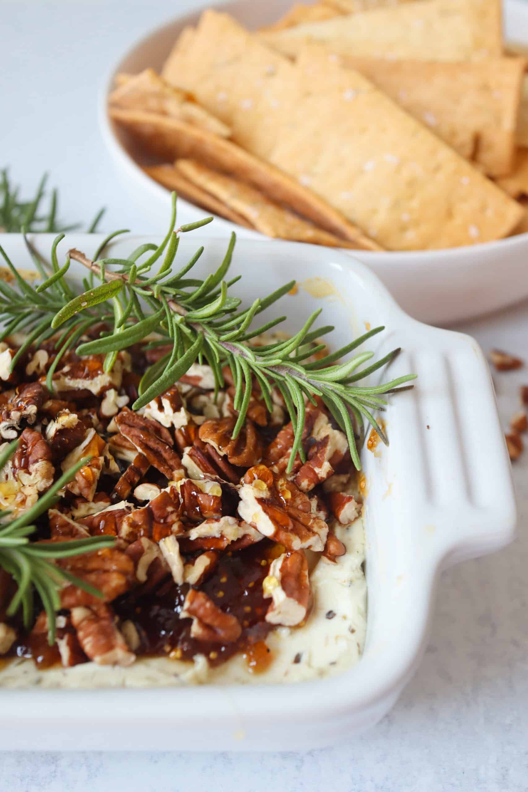 Baked Goat Cheese topped with fig jam, chopped pecans, honey, and fresh rosemary