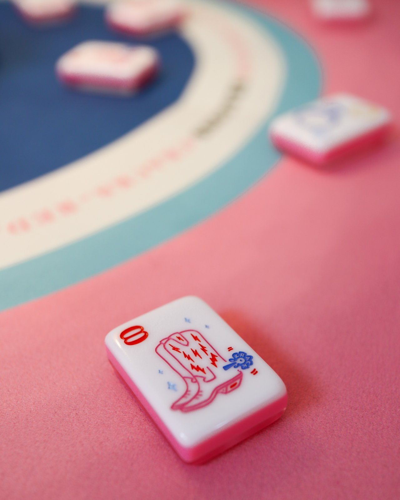 Close-up of cowgirl boot mahjong tiles numbered three and four