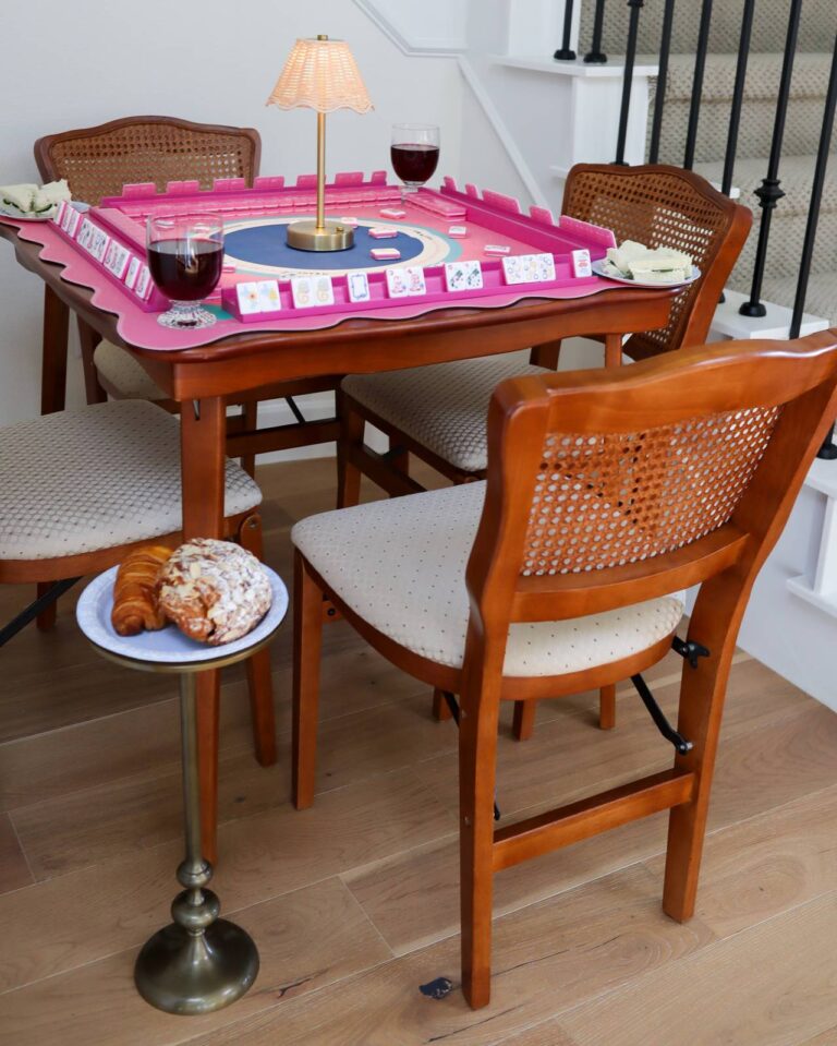 A mahjong party table set with cowgirl tiles, racks, and a Southern spread
