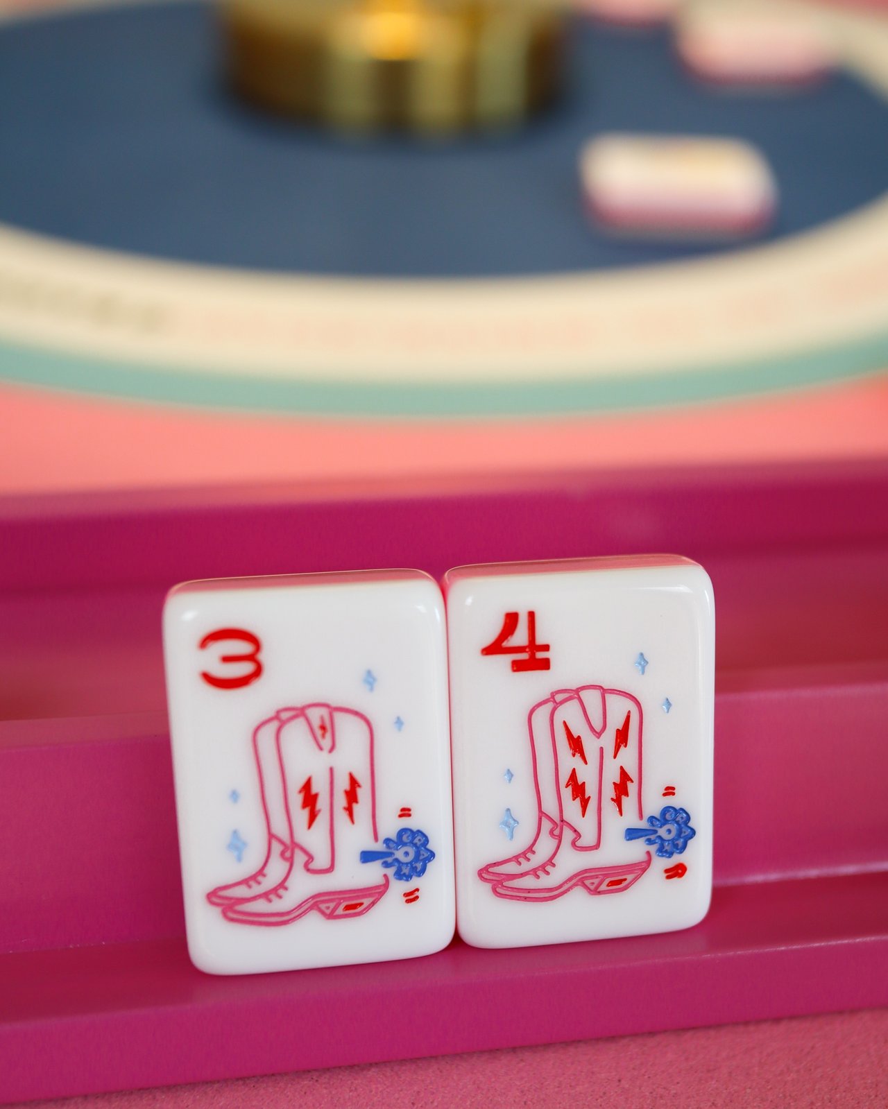 Cowgirl mahjong tiles, wood racks, and a card laid out on the table